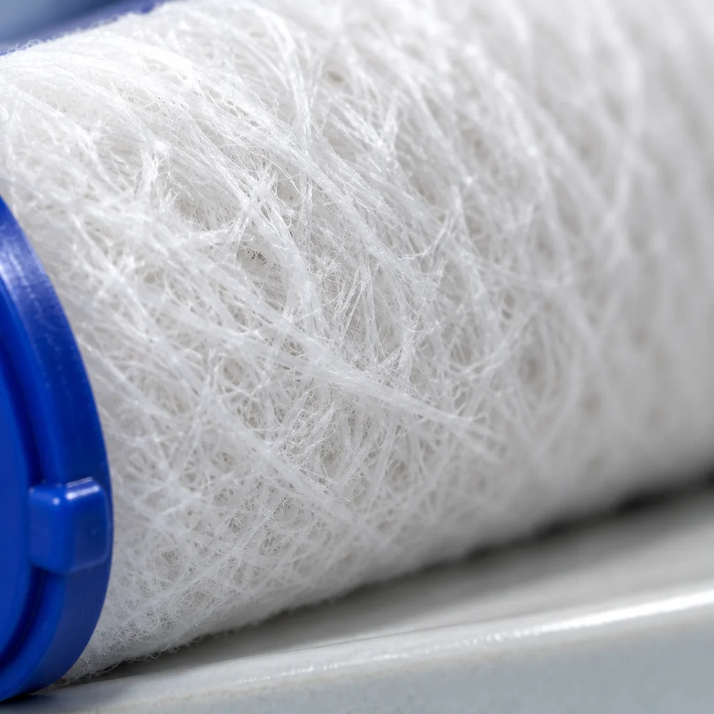 An extreme macro photograph of the white cotton PP fibers inside the exact cylindrical cartridge fro